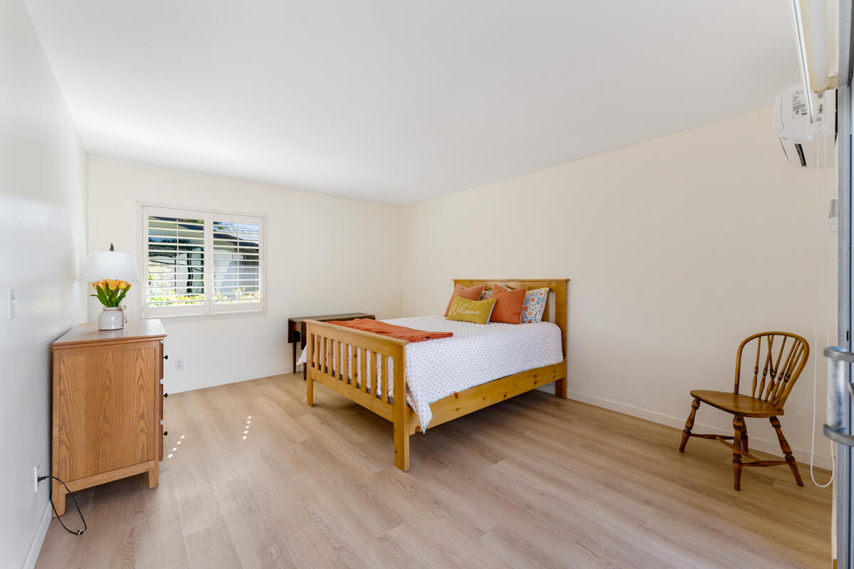 4126 Foothill Road Santa Barbara, CA 93110 - Photo 14 of 32 a bedroom with a bed and wooden floor
