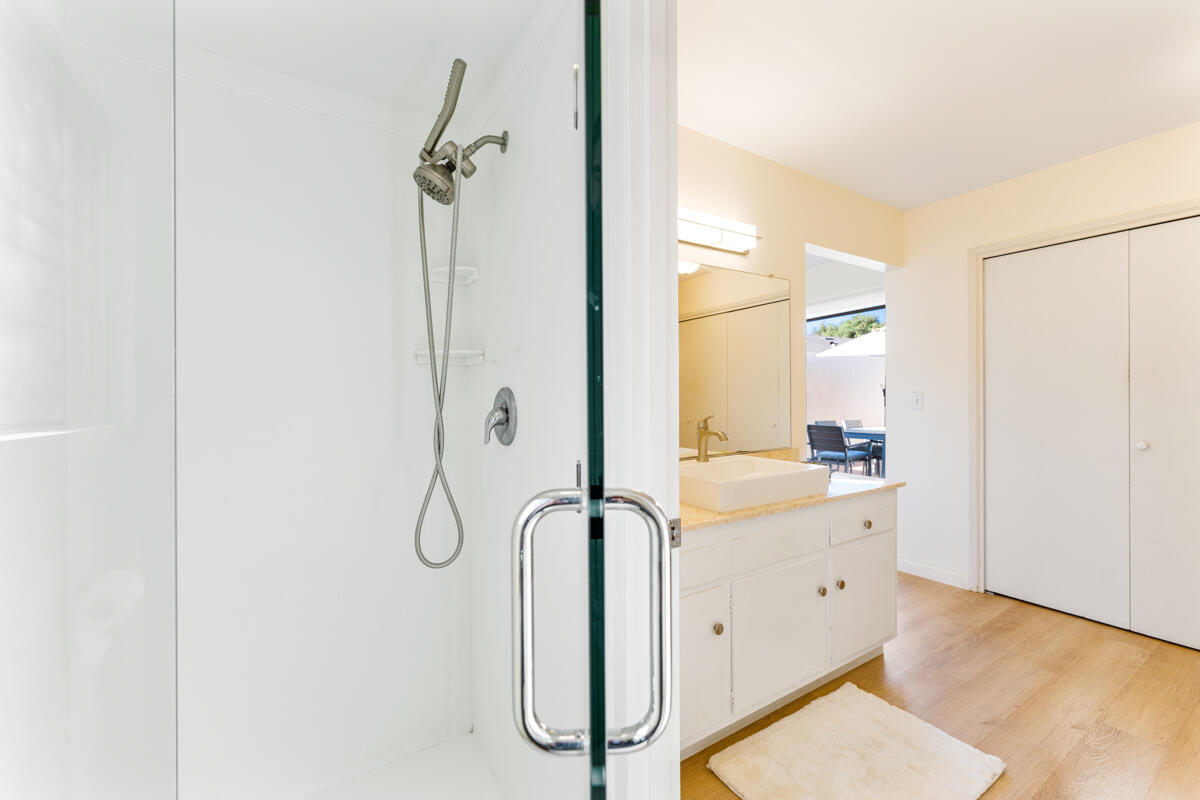 4126 Foothill Road Santa Barbara, CA 93110 - Photo 16 of 32 a bathroom with a granite countertop sink a mirror and shower