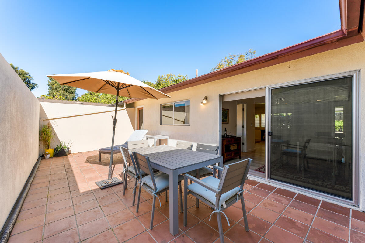 4126 Foothill Road Santa Barbara, CA 93110 - Photo 23 of 32 a patio with a table and chairs under an umbrella