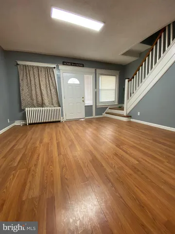 a large kitchen with stainless steel appliances wooden cabinets a stove and a refrigerator