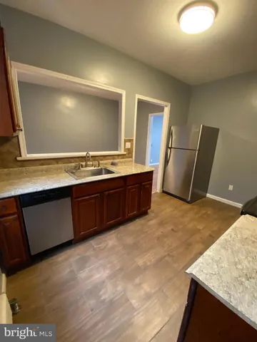 a spacious bathroom with a granite countertop sink a toilet and shower