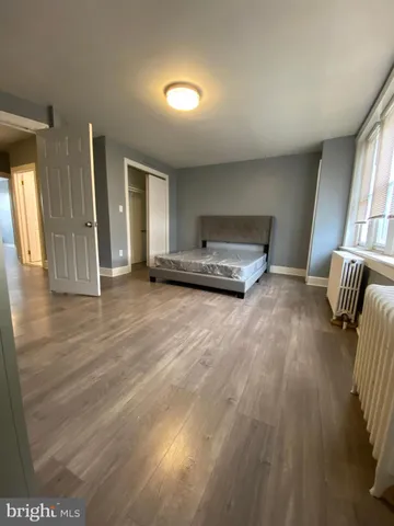 an empty room with wooden floor and closet