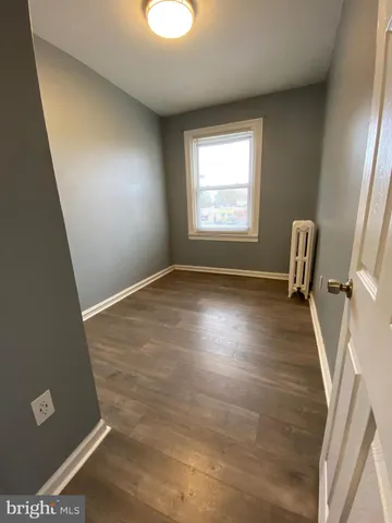 a view of an entryway with wooden floor and door