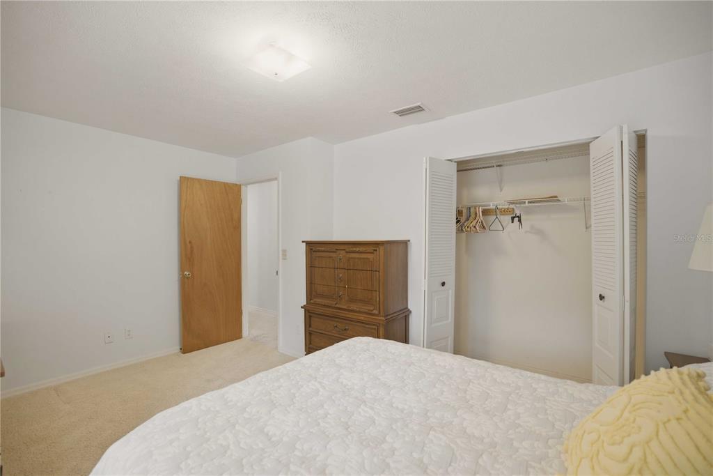 3654 Southeast 68th Street Ocala, FL 34480 - Photo 11 of 25 a bedroom with a bed and a bathroom