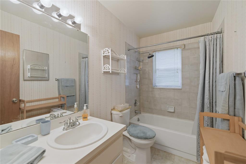 3654 Southeast 68th Street Ocala, FL 34480 - Photo 12 of 25 a bathroom with a sink a toilet a mirror and bathtub