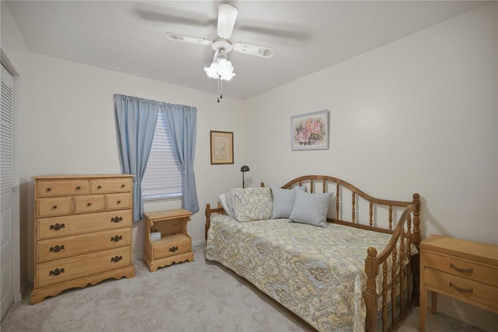 3654 Southeast 68th Street Ocala, FL 34480 - Photo 13 of 25 a bedroom with furniture and a chandelier