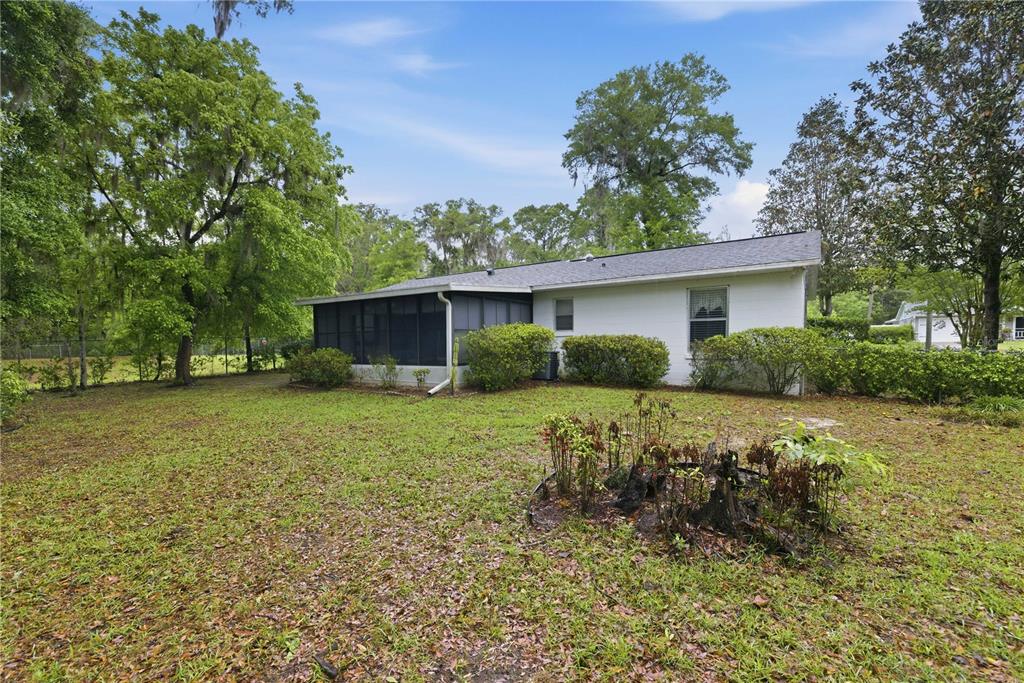 3654 Southeast 68th Street Ocala, FL 34480 - Photo 20 of 25 a front view of house with yard and trees