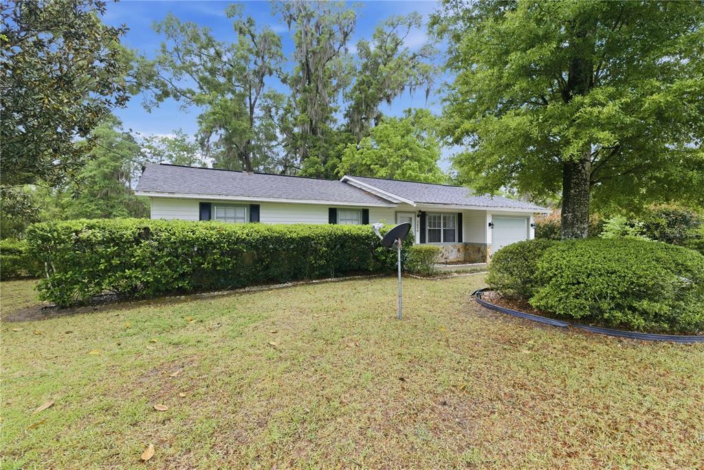 3654 Southeast 68th Street Ocala, FL 34480 - Photo 3 of 25 a house with trees in the background