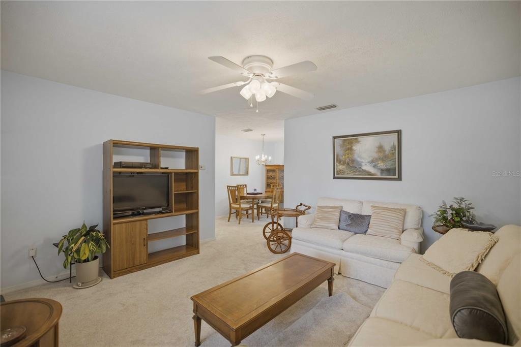 3654 Southeast 68th Street Ocala, FL 34480 - Photo 5 of 25 a living room with furniture and a flat screen tv