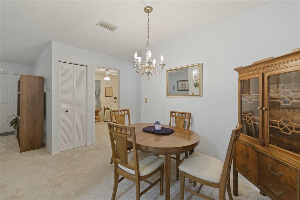 3654 Southeast 68th Street Ocala, FL 34480 - Photo 7 of 25 a view of a dining room with furniture and chandelier