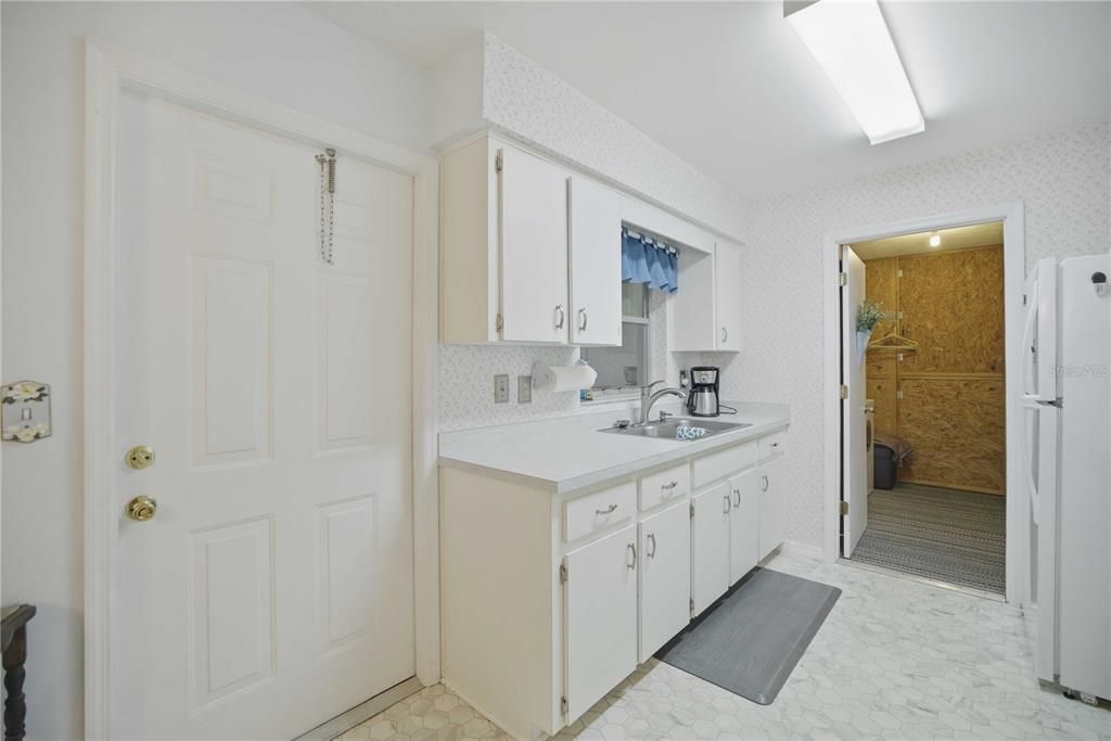 3654 Southeast 68th Street Ocala, FL 34480 - Photo 9 of 25 a bathroom with a sink a mirror and a shower