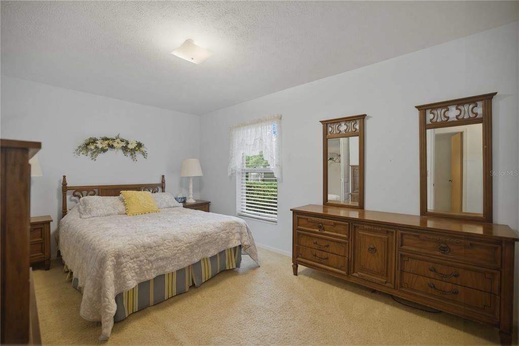 3654 Southeast 68th Street Ocala, FL 34480 - Photo 10 of 25 a bedroom with a bed and a dresser in it