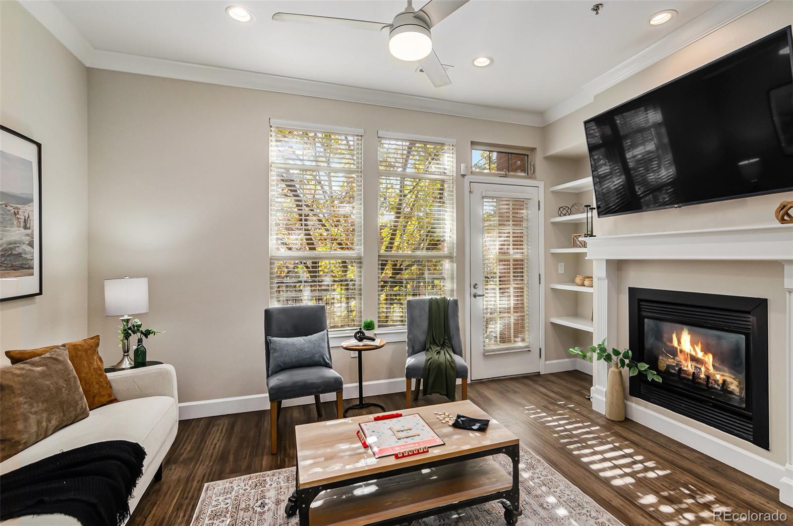 a living room with furniture a flat screen tv and a fireplace