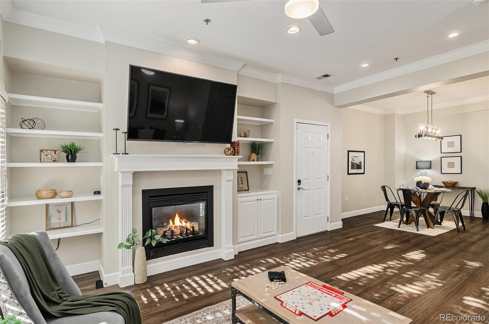 2580 17th Street, Unit 202 Denver, CO 80211 - Photo 2 of 32 a living room with furniture a flat screen tv and a fireplace