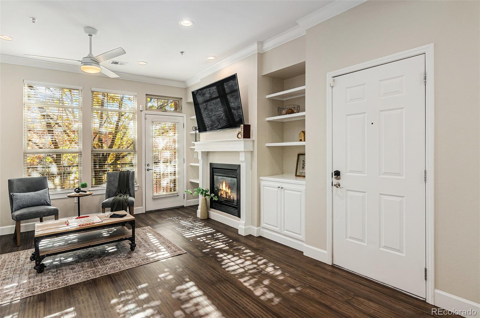 2580 17th Street, Unit 202 Denver, CO 80211 - Photo 3 of 32 a living room with furniture a flat screen tv and a fireplace