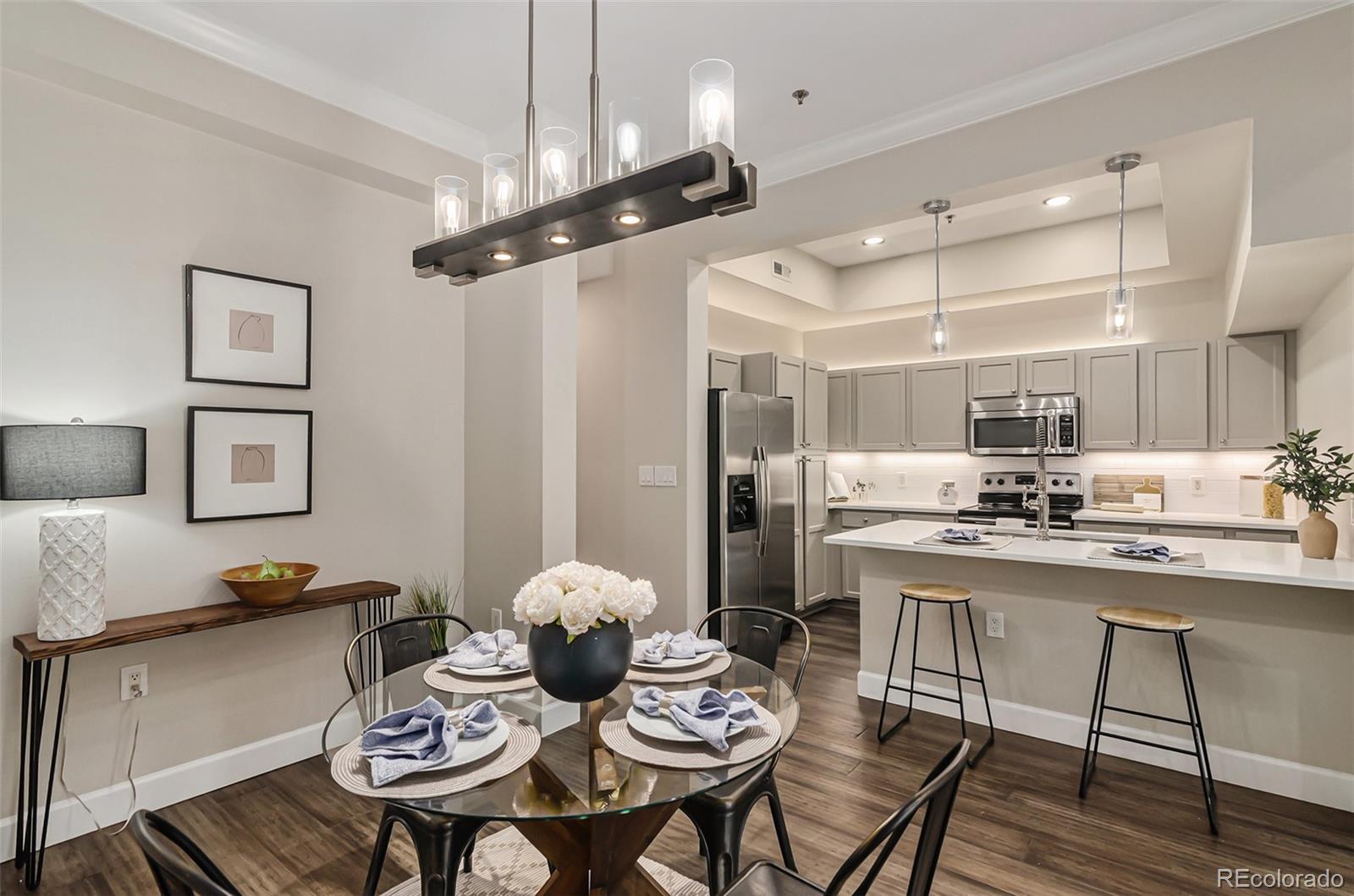 2580 17th Street, Unit 202 Denver, CO 80211 - Photo 6 of 32 a kitchen with a dining table and chairs