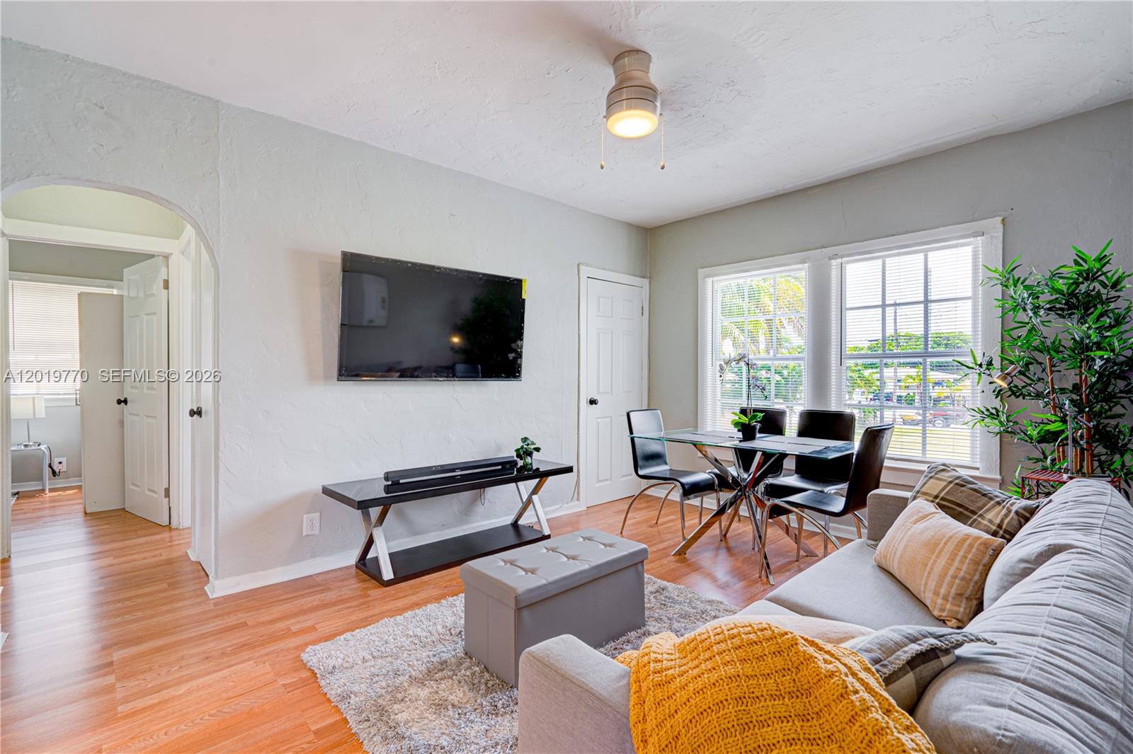 227 Southwest 30th Avenue, Unit B Miami, FL 33135 - Photo 5 of 15 a living room with furniture and a flat screen tv