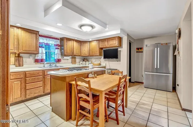 a kitchen with stainless steel appliances granite countertop a stove a sink a microwave and a refrigerator