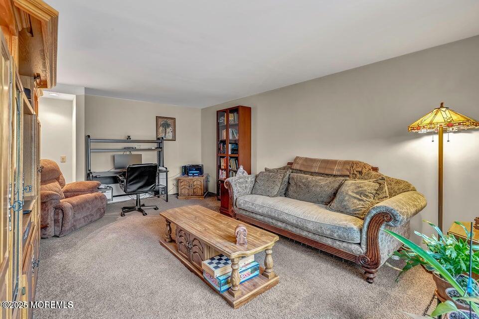 718 East Veterans Highway Jackson, NJ 08527 - Photo 15 of 32 a living room with furniture a lamp and a fireplace