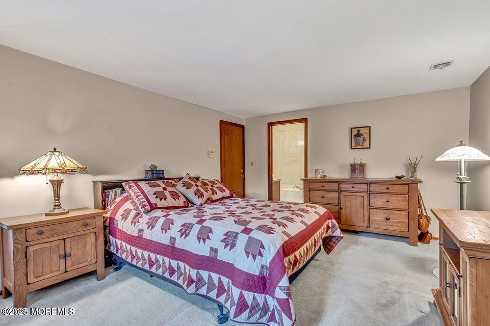 718 East Veterans Highway Jackson, NJ 08527 - Photo 21 of 32 a bedroom with a bed and a chandelier