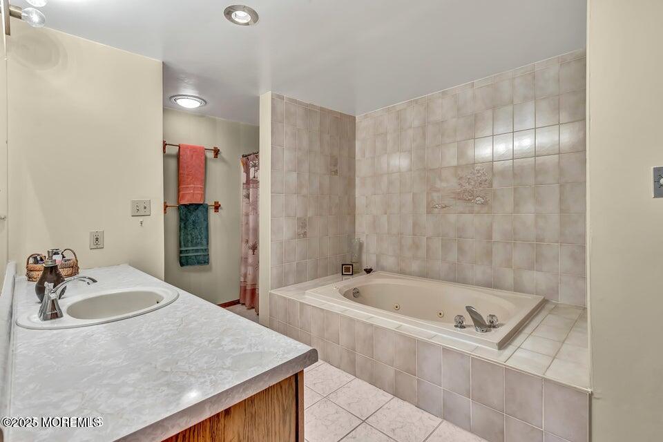 718 East Veterans Highway Jackson, NJ 08527 - Photo 23 of 32 a bathroom with a tub sink and mirror