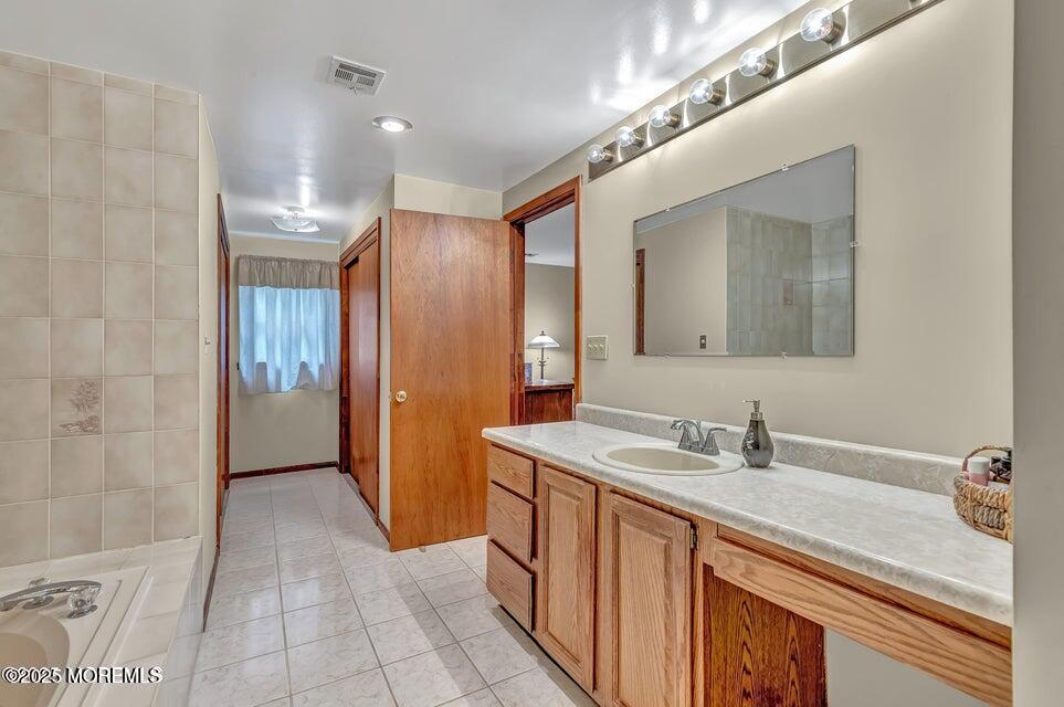718 East Veterans Highway Jackson, NJ 08527 - Photo 24 of 32 a bathroom with a double vanity sink and a mirror