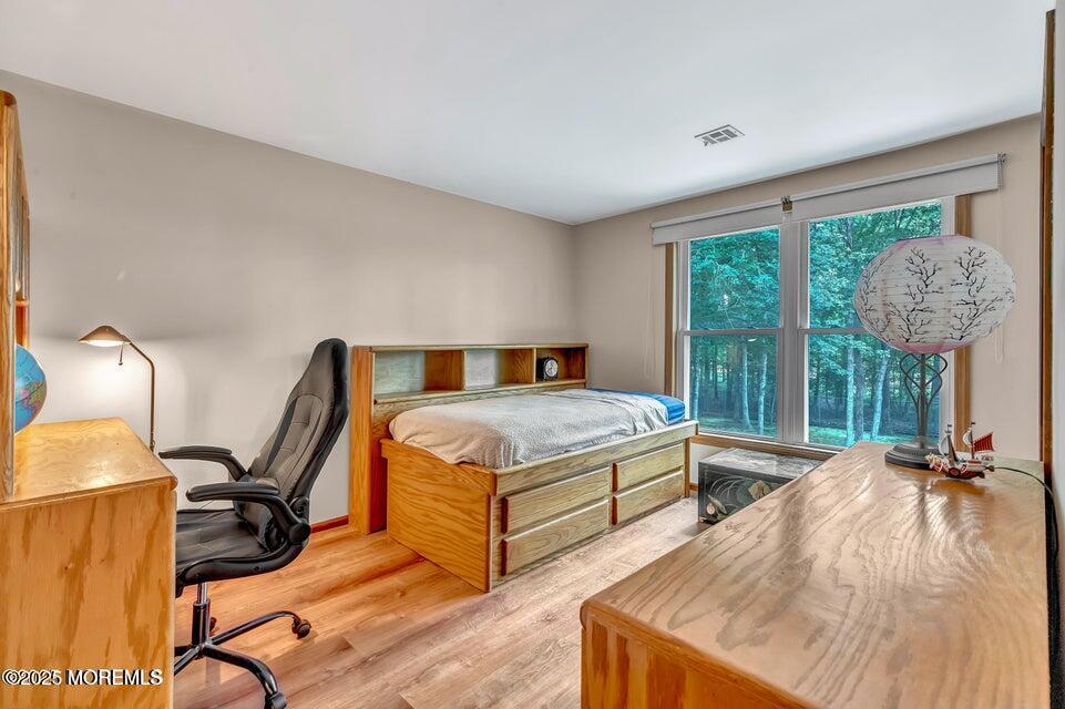 718 East Veterans Highway Jackson, NJ 08527 - Photo 26 of 32 a bedroom with a bed a lamp and a large window