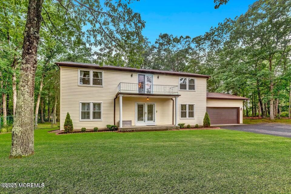 718 East Veterans Highway Jackson, NJ 08527 - Photo 3 of 32 a front view of house with a garden and trees