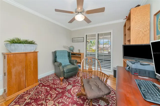 a living room with kitchen view and a wooden floor
