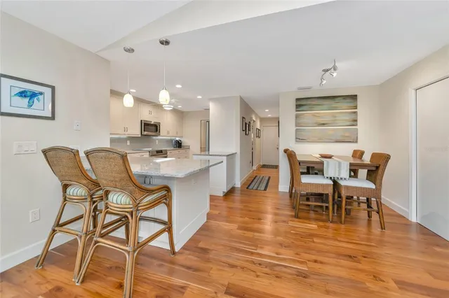 a bathroom with a granite countertop toilet sink and mirror