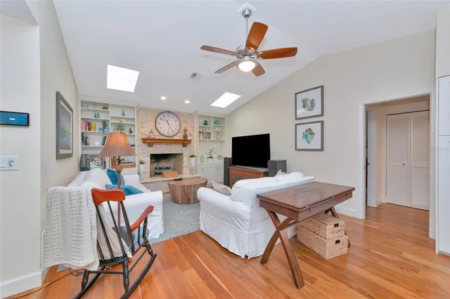 a couple of palm trees in front of yellow house