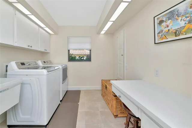an aerial view of residential houses with outdoor space and ocean view