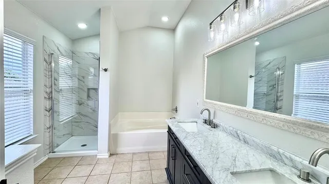 a bathroom with a granite countertop sink a toilet and shower
