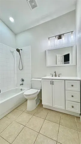 a bathroom with a toilet a sink a mirror and bathtub