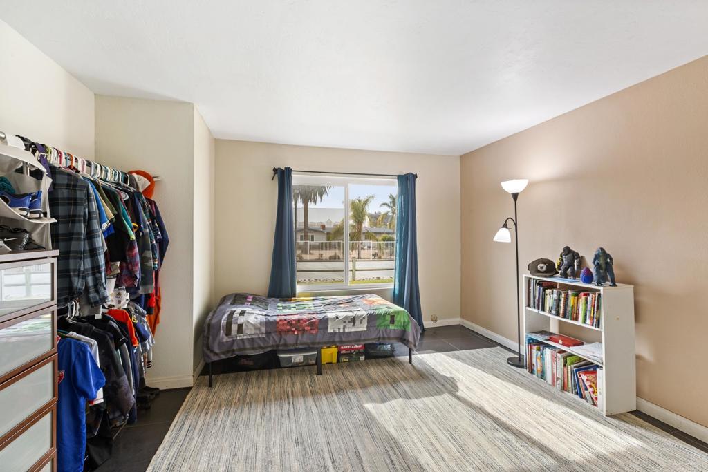1768 Regency Way, Unit D Chula Vista, CA 91911 - Photo 13 of 32 a bedroom with furniture and a book shelf