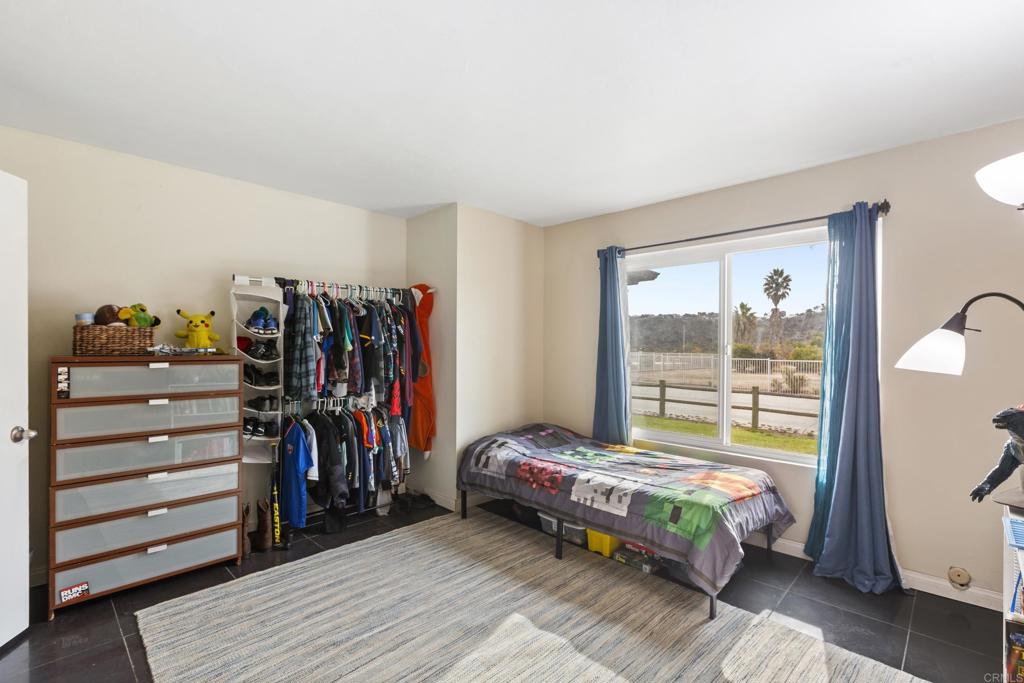 1768 Regency Way, Unit D Chula Vista, CA 91911 - Photo 14 of 32 a bedroom with a bed and a window