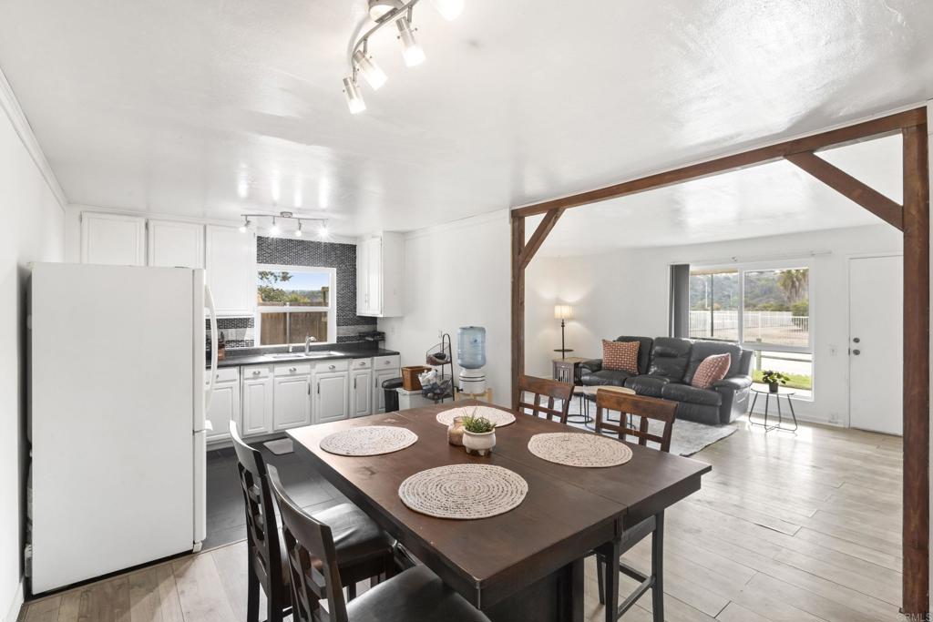 1768 Regency Way, Unit D Chula Vista, CA 91911 - Photo 9 of 32 a dining room with furniture and wooden floor