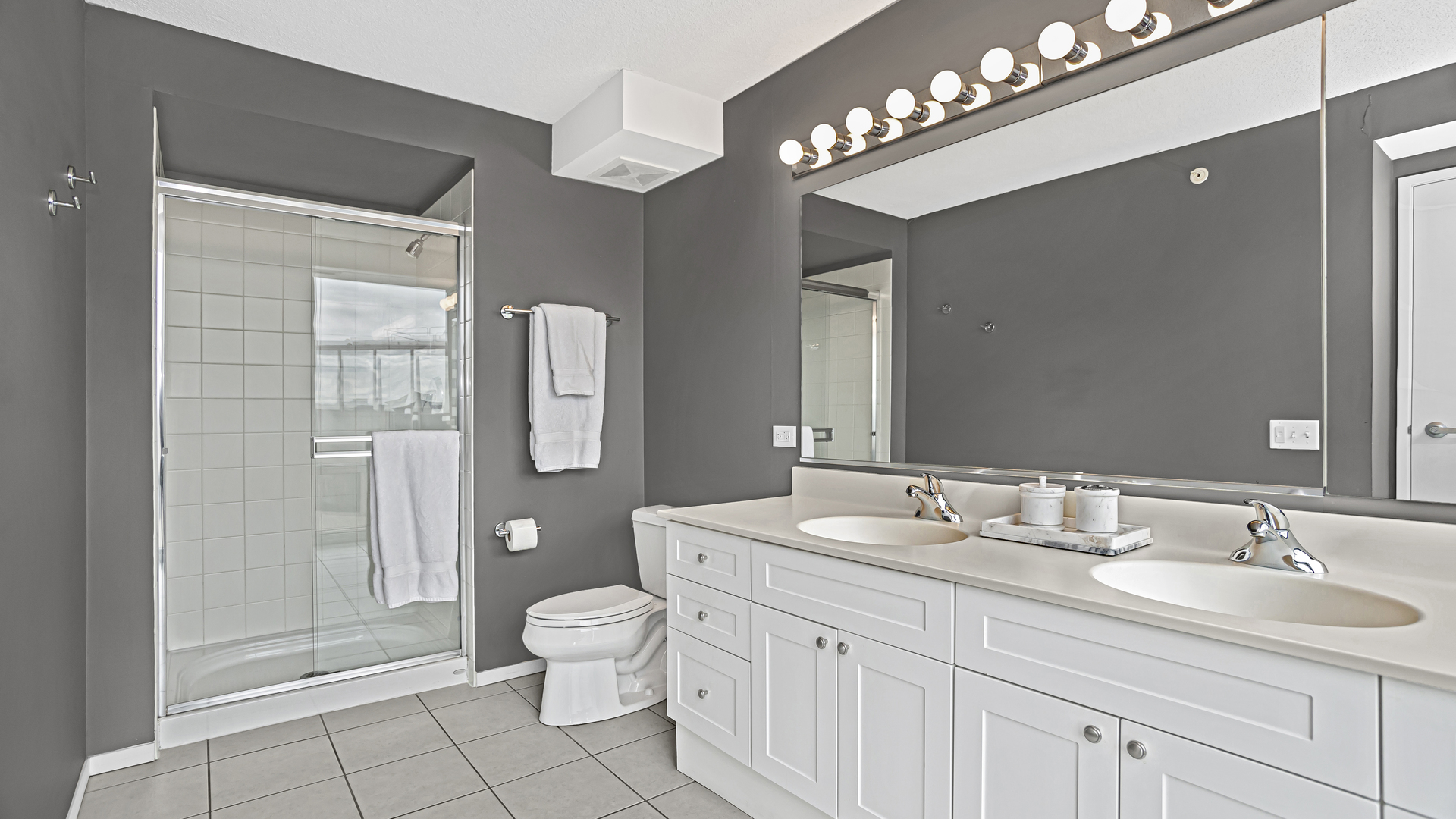 800 Elgin Road, Unit 1221 Evanston, IL 60201 - Photo 11 of 23 a spacious bathroom with a double vanity sink a toilet and a mirror