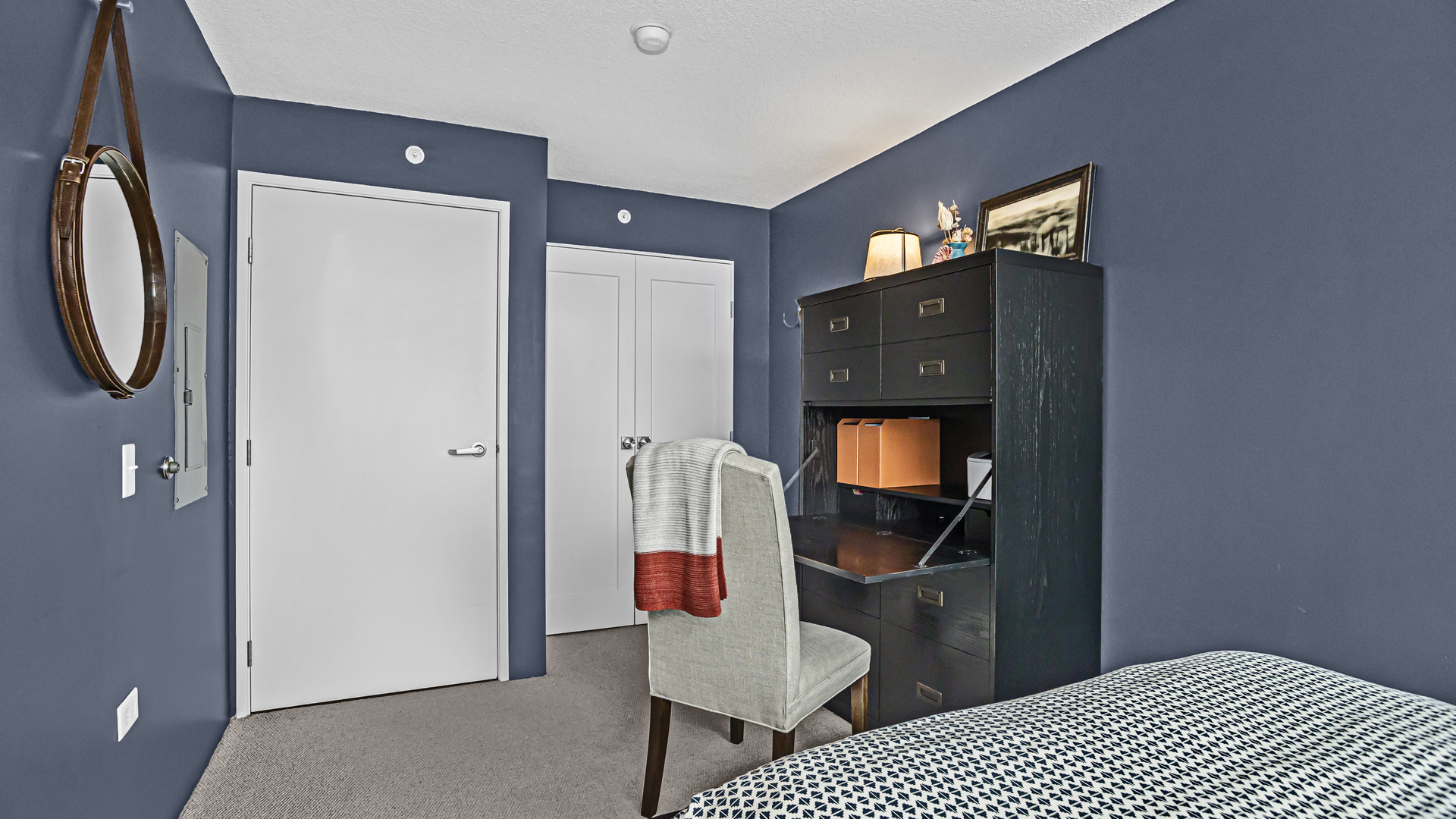 800 Elgin Road, Unit 1221 Evanston, IL 60201 - Photo 13 of 23 a bedroom with a bed and a mirror on dresser