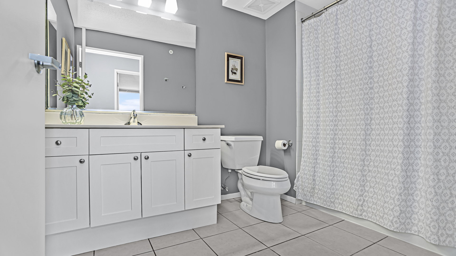 800 Elgin Road, Unit 1221 Evanston, IL 60201 - Photo 14 of 23 a bathroom with a toilet a sink and mirror