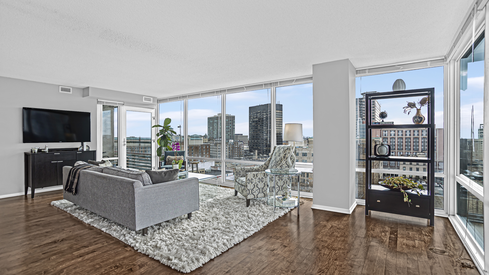 800 Elgin Road, Unit 1221 Evanston, IL 60201 - Photo 2 of 23 a living room with furniture and a flat screen tv