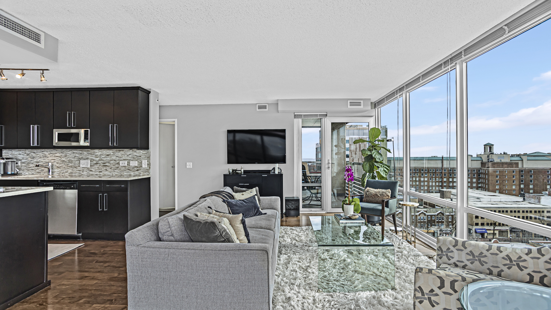 800 Elgin Road, Unit 1221 Evanston, IL 60201 - Photo 3 of 23 a living room with furniture a flat screen tv and a fireplace