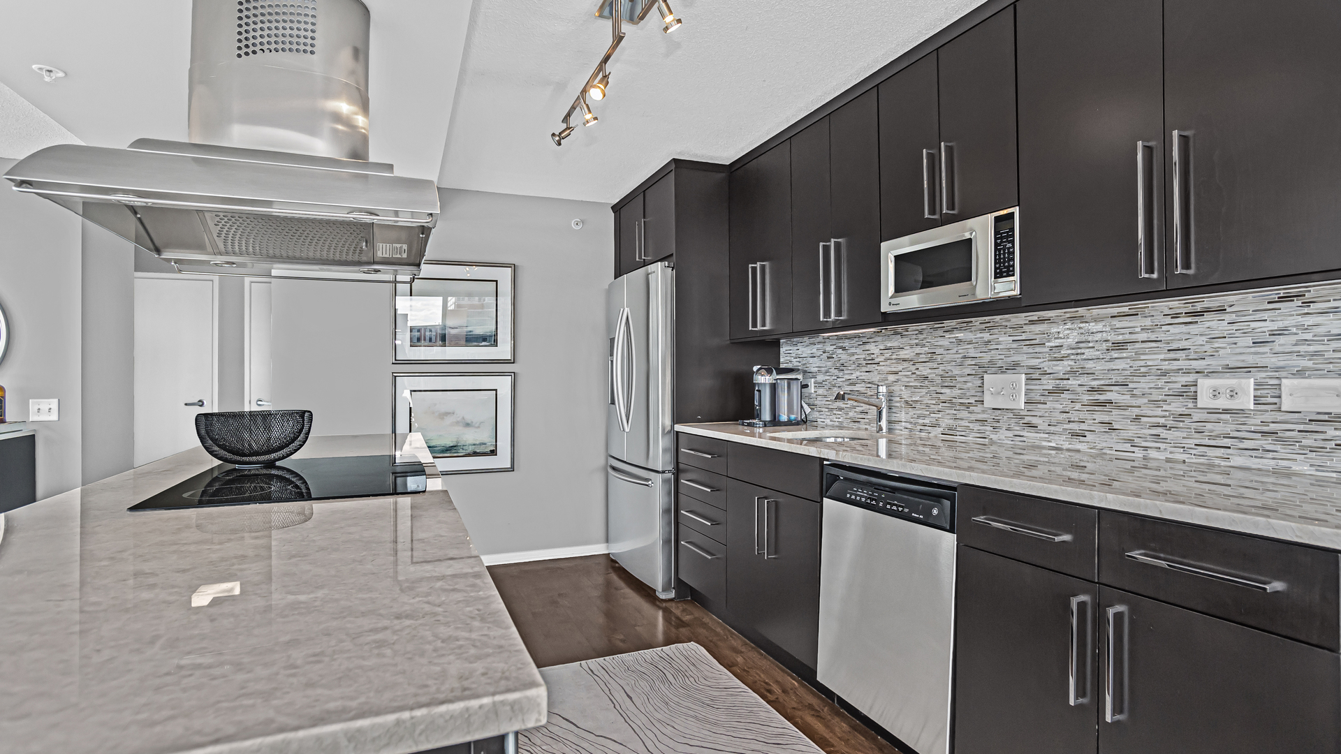 800 Elgin Road, Unit 1221 Evanston, IL 60201 - Photo 6 of 23 a kitchen with stainless steel appliances kitchen island granite countertop a refrigerator and a stove