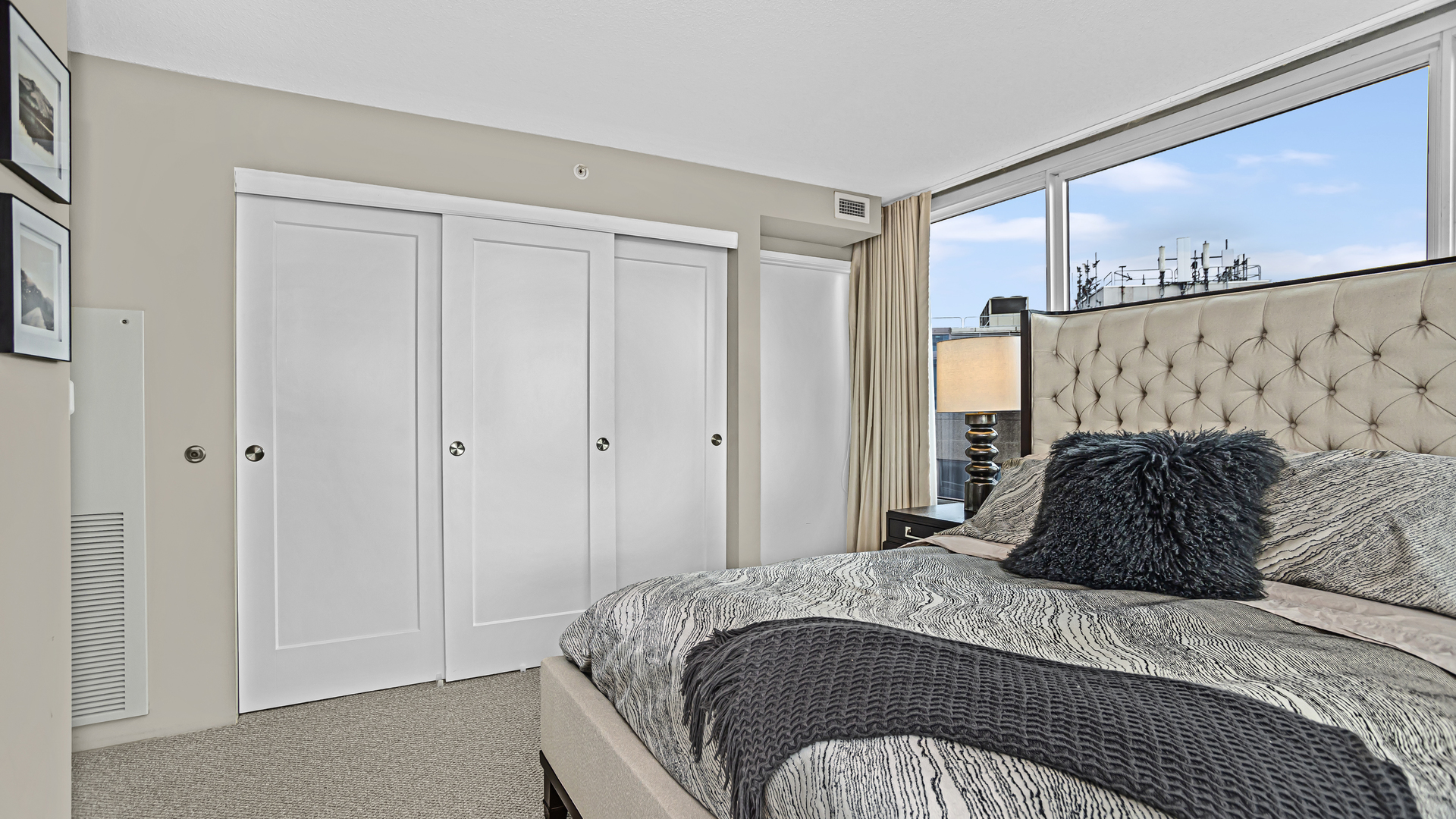 800 Elgin Road, Unit 1221 Evanston, IL 60201 - Photo 10 of 23 a bedroom with a bed and a walk in closet