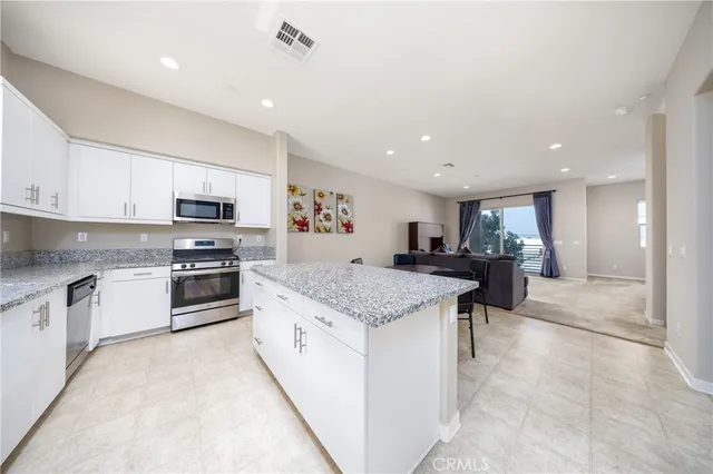 a kitchen with stainless steel appliances granite countertop a sink and cabinets