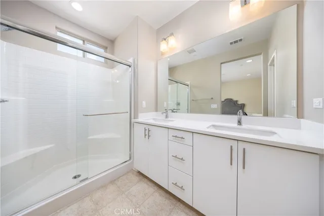 a bathroom with a shower sink and mirror