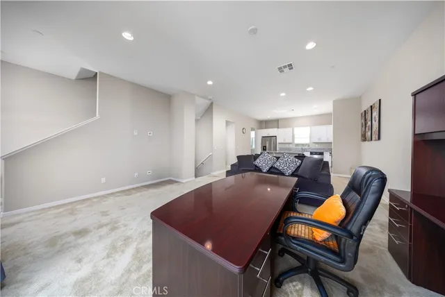 a living room with furniture pool table and a window
