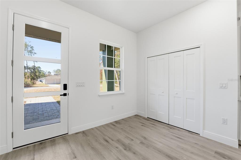 4473 Southwest 168th Lane Ocala, FL 34473 - Photo 14 of 33 an empty room with wooden floor and windows