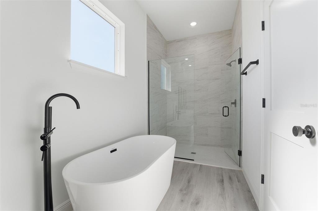 4473 Southwest 168th Lane Ocala, FL 34473 - Photo 18 of 33 a bathroom with a tub and a shower