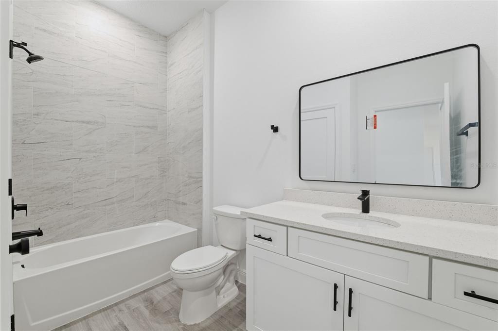 4473 Southwest 168th Lane Ocala, FL 34473 - Photo 22 of 33 a bathroom with a sink a toilet and shower